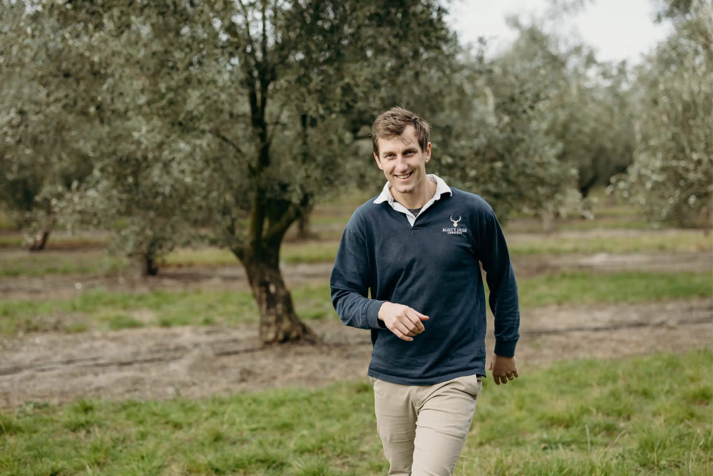 Tim Groves, founder and Shopify expert at Blank Slate Co., walking in a field in New Zealand.